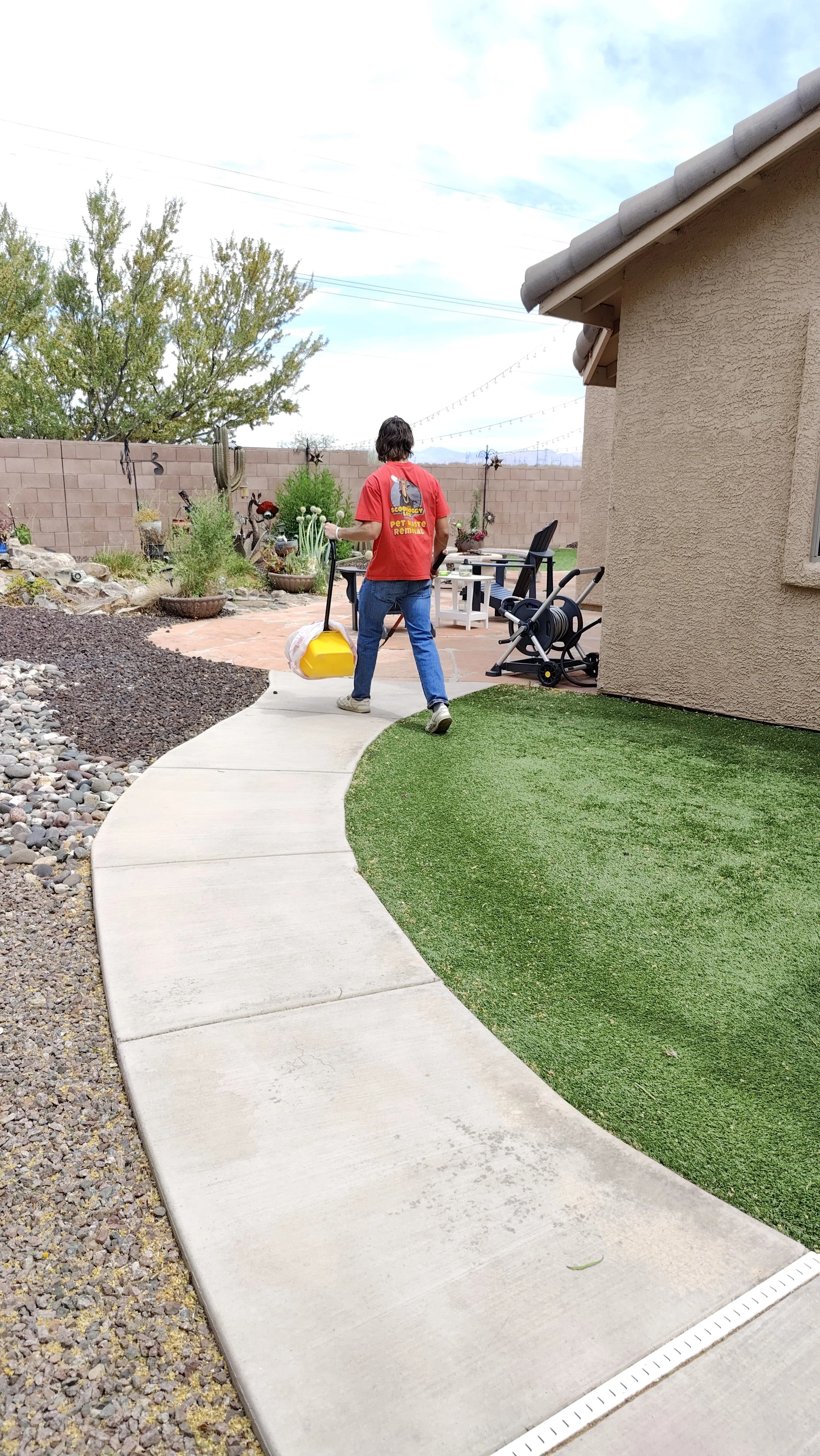Scoop Doggy Logs crew member working on a Tucson yard cleanup route