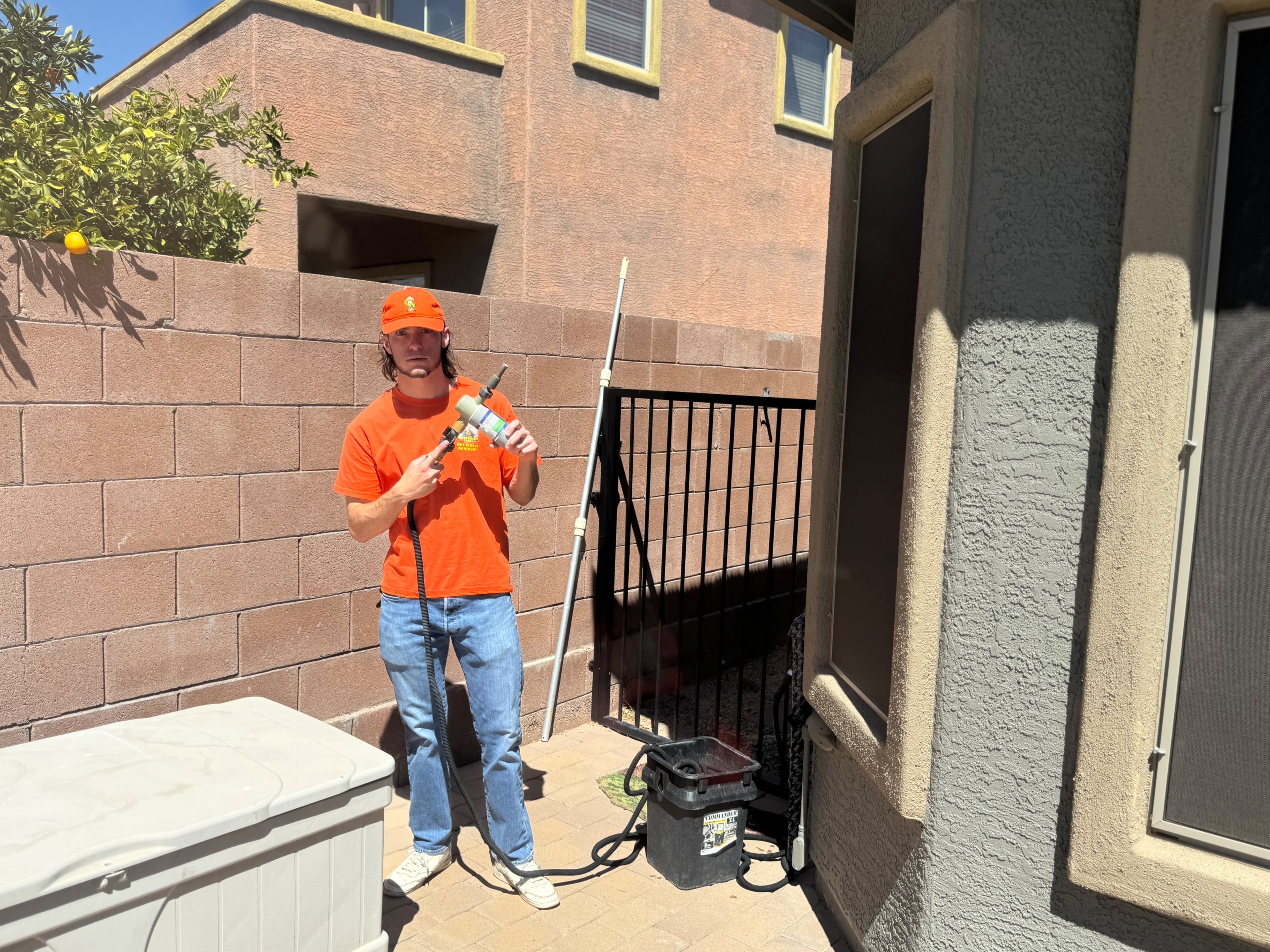 Scoop Doggy Logs team member applying deodorizer treatment