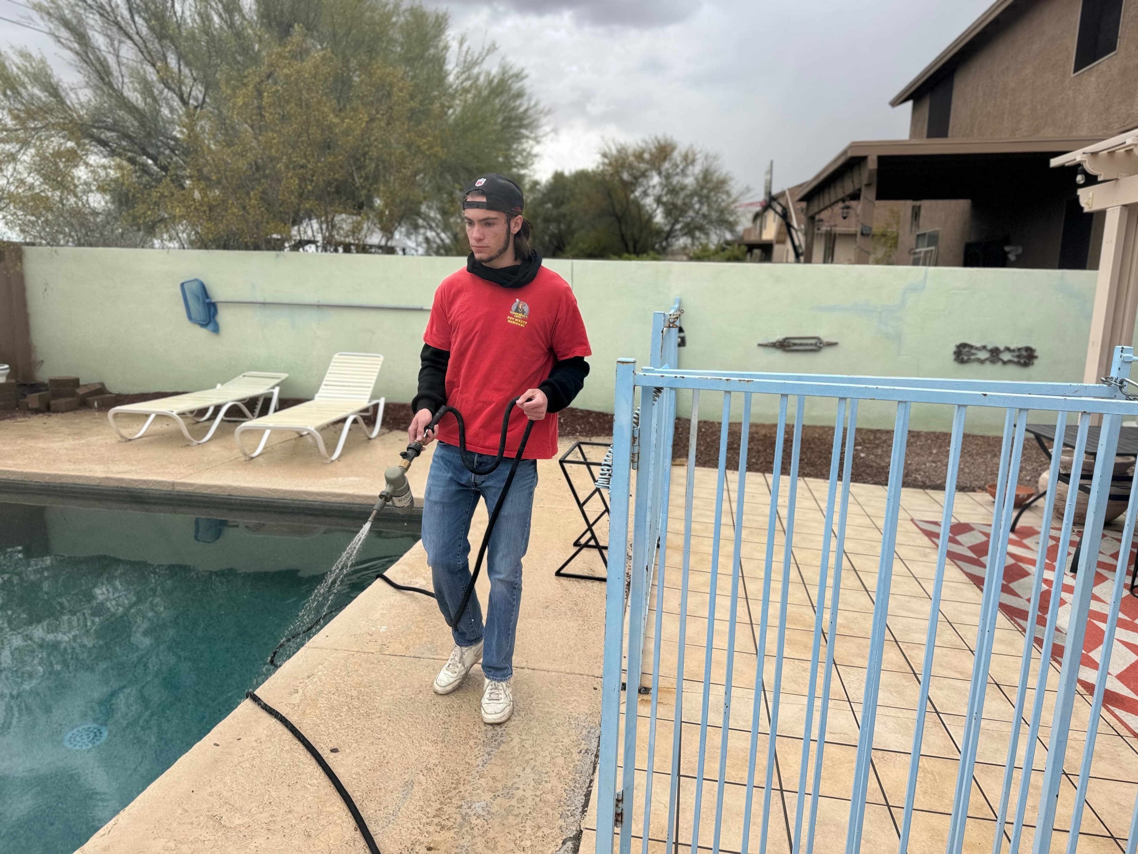 Crew member applying deodorizer in a yard
