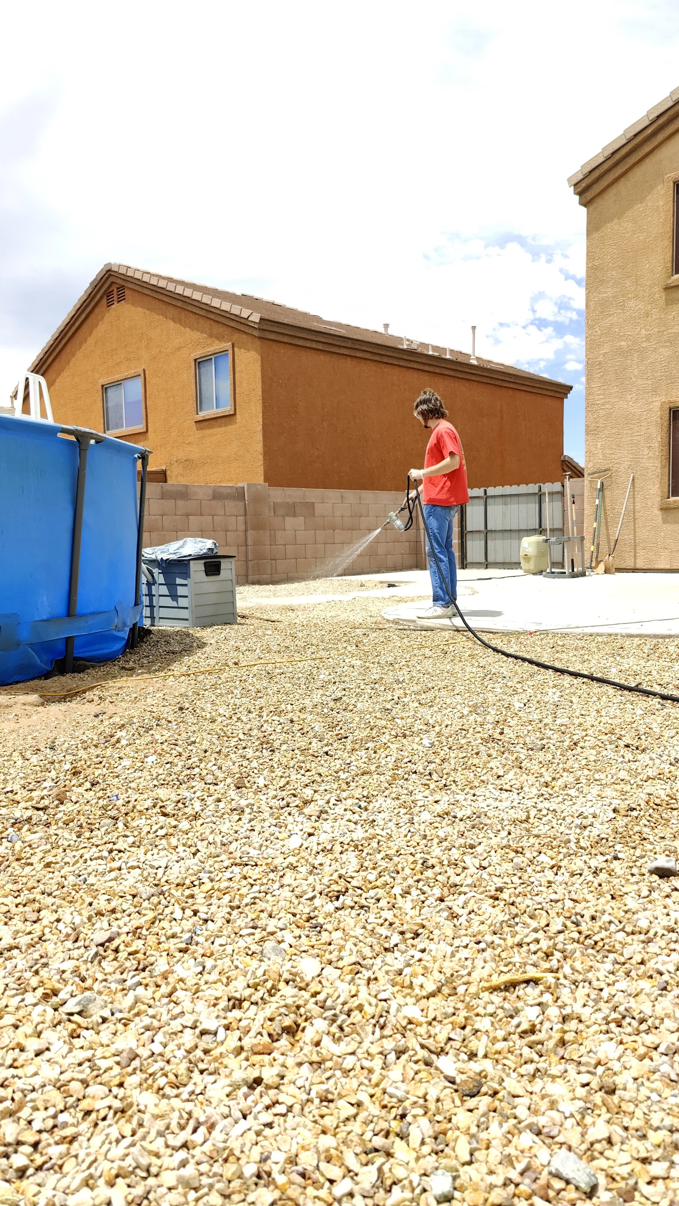 Scoop Doggy Logs crew applying deodorizer treatment to a Tucson yard