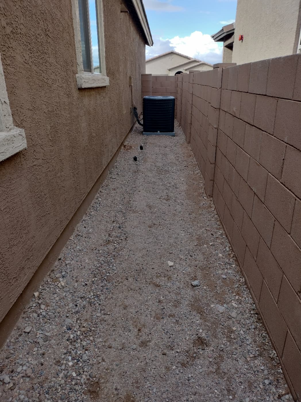 Backyard with rock landscaping and a neat lawn strip