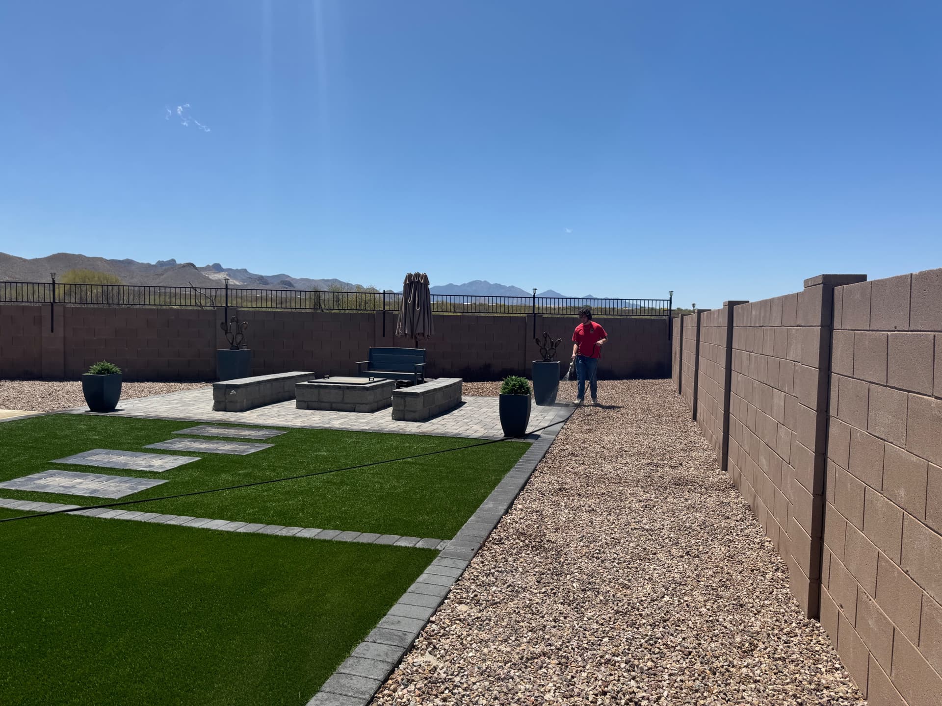 Well-kept backyard with turf and desert wall